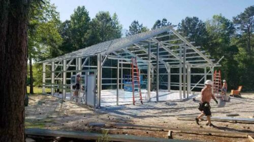 The construction is of a large metal frame structure with a peaked roof.