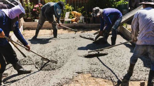 A group of construction workers set the foundation for Metal Building Construction