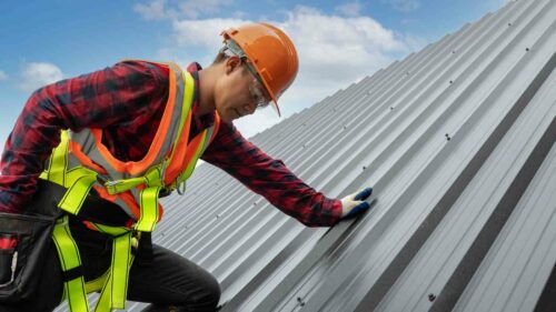 A roofing expert installing standing seam metal roof