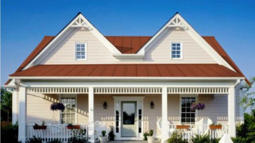 Red Metal Roof with Cream House