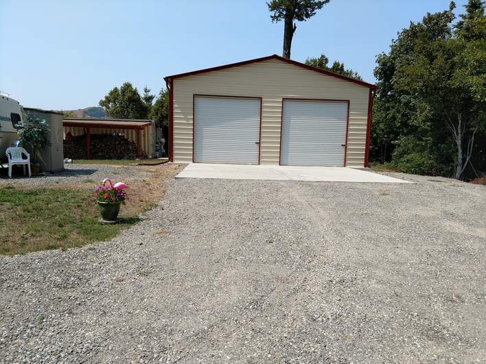 30×31×12 metal building installed by Steel and Stud — engineered roof and side panels and a 10×10 roll-up door