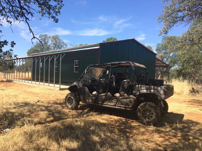 54×51 metal building installed by Steel and Stud — engineered roof and side panels and a 10×10 roll-up door