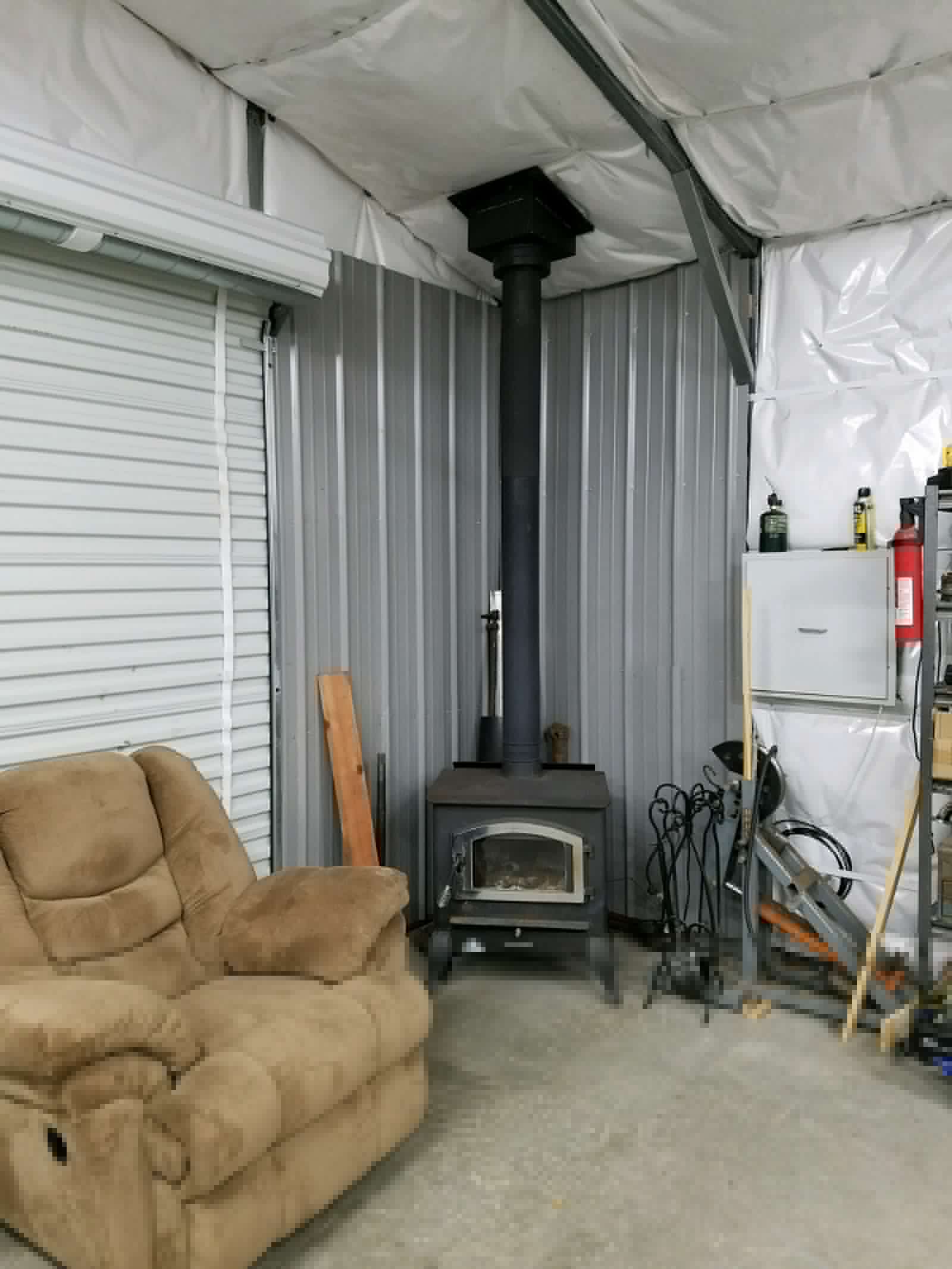 28×31×9 metal building installed by Steel and Stud, Maryland — engineered roof and side panels and a 10×8 roll-up door — interior buildout view