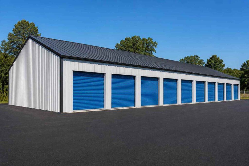 White metal building kit self storage facility with blue roll-up doors and black roof