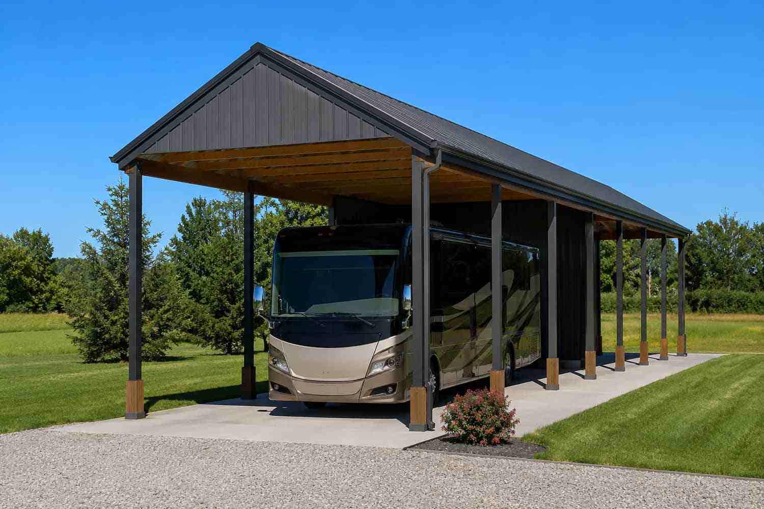 Black RV metal cover with open sides sheltering a Class A motorhome on a concrete pad