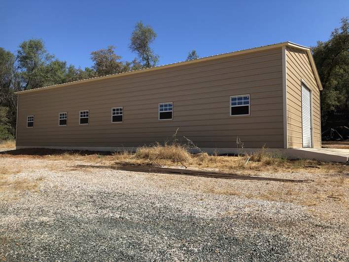 metal building installed by Steel and Stud — engineered roof and side panels — Tong customer install (California)